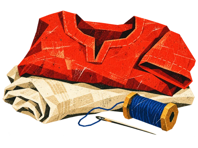 A folded red tunic rests on cream linen beside a blue thread spool and needle.