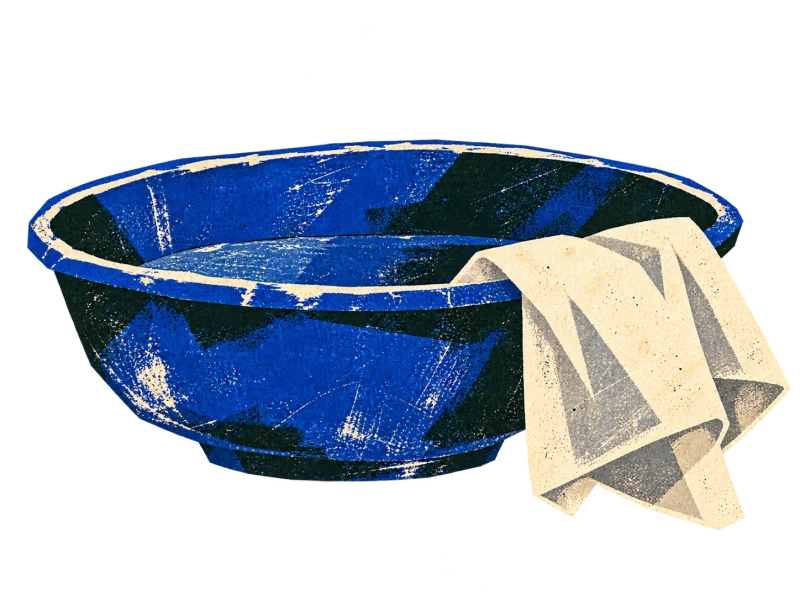 A cream linen towel draped over the rim of a roughly painted blue wash basin.