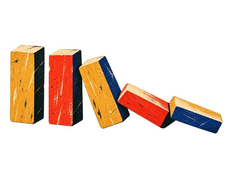 Five plain ochre, red and blue wooden dominoes form a falling chain.