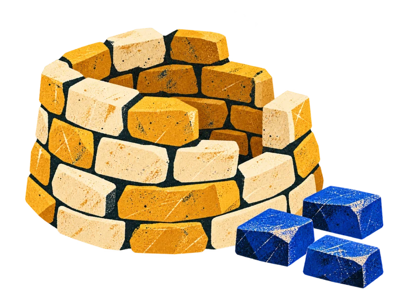An unfinished low stone tower with an uneven top and three blue building blocks beside it.