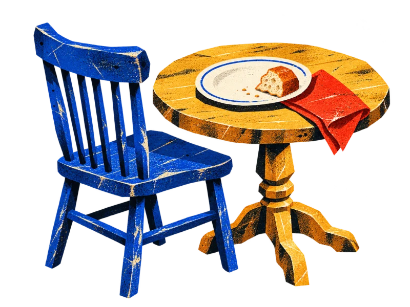 An empty blue chair at an ochre table set with a cream plate, bread, and a red napkin.